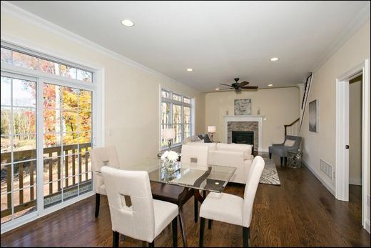 Dining area with glass table opening to a rear deck — Storybook Homes NJ