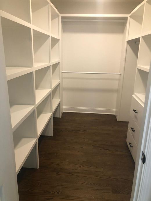 Walk-in closet with custom white shelving — Storybook Homes NJ