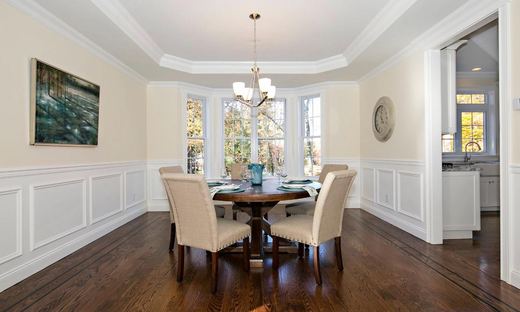 Dining room with round table and bay window seating — Storybook Homes NJ