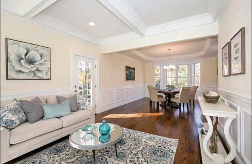 Living room with bay window and gray sofas — Storybook Homes NJ