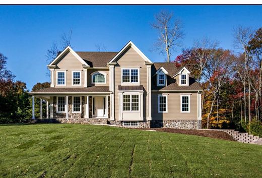 Tan Cape Cod-style colonial with covered porch — Storybook Homes NJ