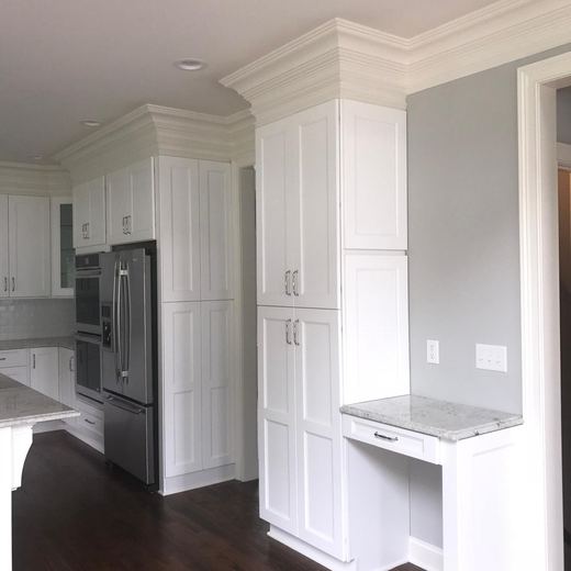 Kitchen pantry wall with built-in cabinetry and stainless refrigerator — Storybook Homes NJ