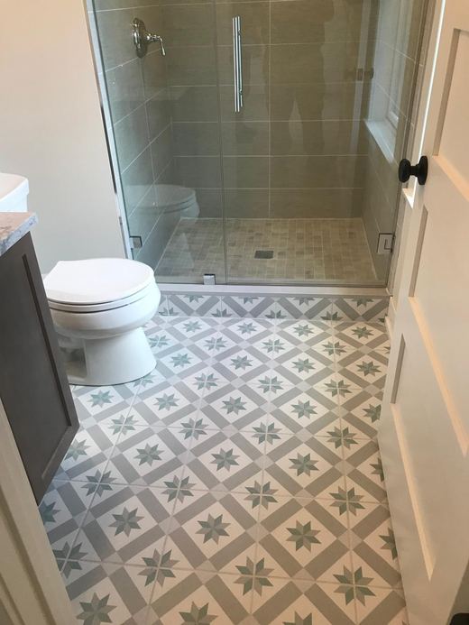 Bathroom with glass shower and patterned tile floor — Storybook Homes NJ